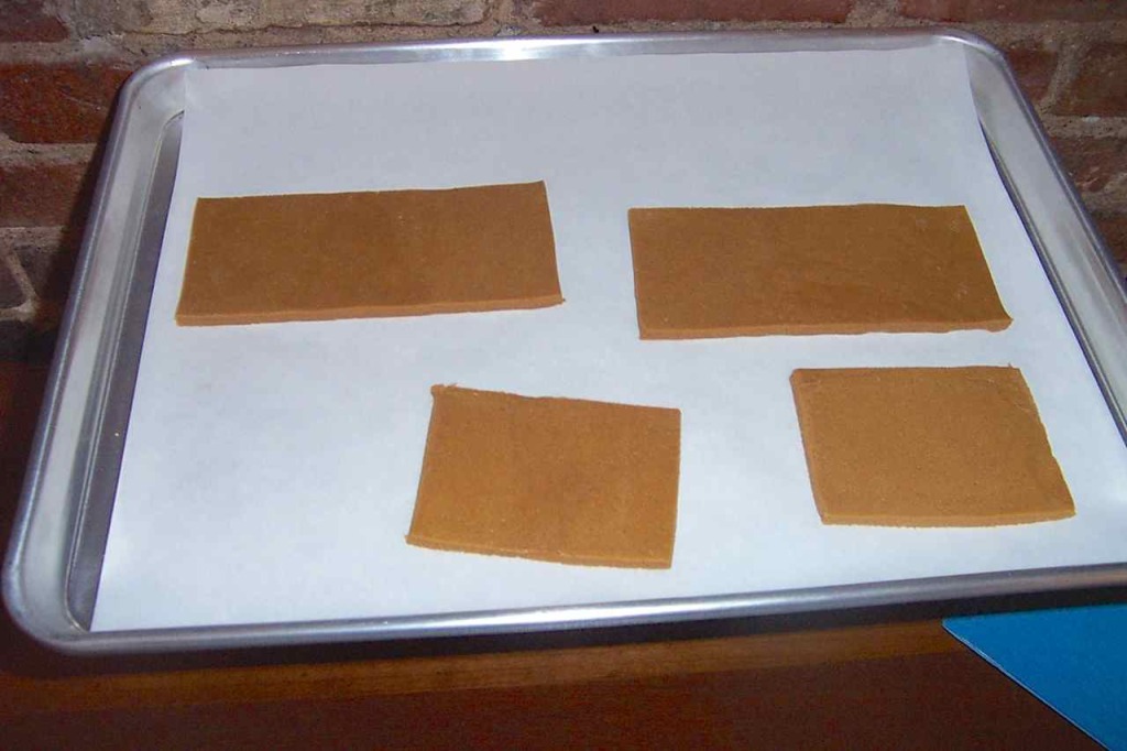 Raw gingerbread dough on cookie sheet cut to form "box" inside of Santa's Sleigh decoration. 