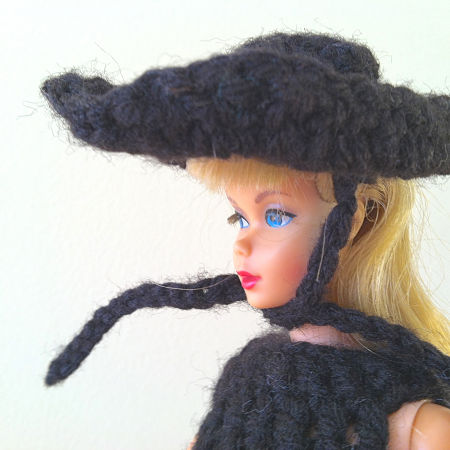 close up of Barbie in black crocheted hat 