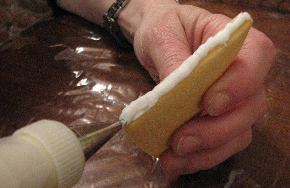 Royal icing piped along cookie edge as "glue" for sides of sleigh "box" 